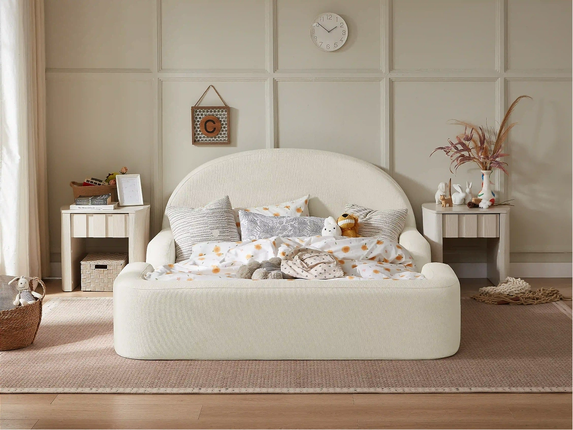 White bed with decorative pillows in a bedroom setting with side tables and decor items.